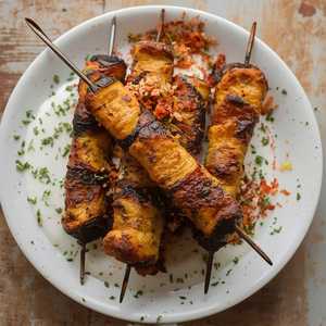 Crispy aubergine skewer, shatta herb sauce, labneh & grape molasses